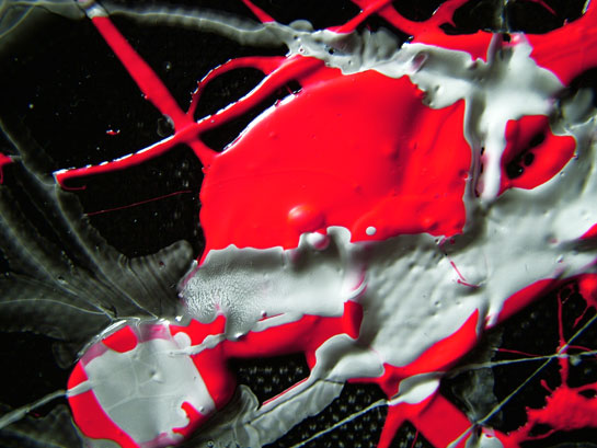 Detail of abstract drip art painting in black enamel gloss