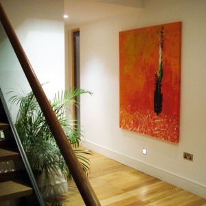 abstract painting hanging in a hallway